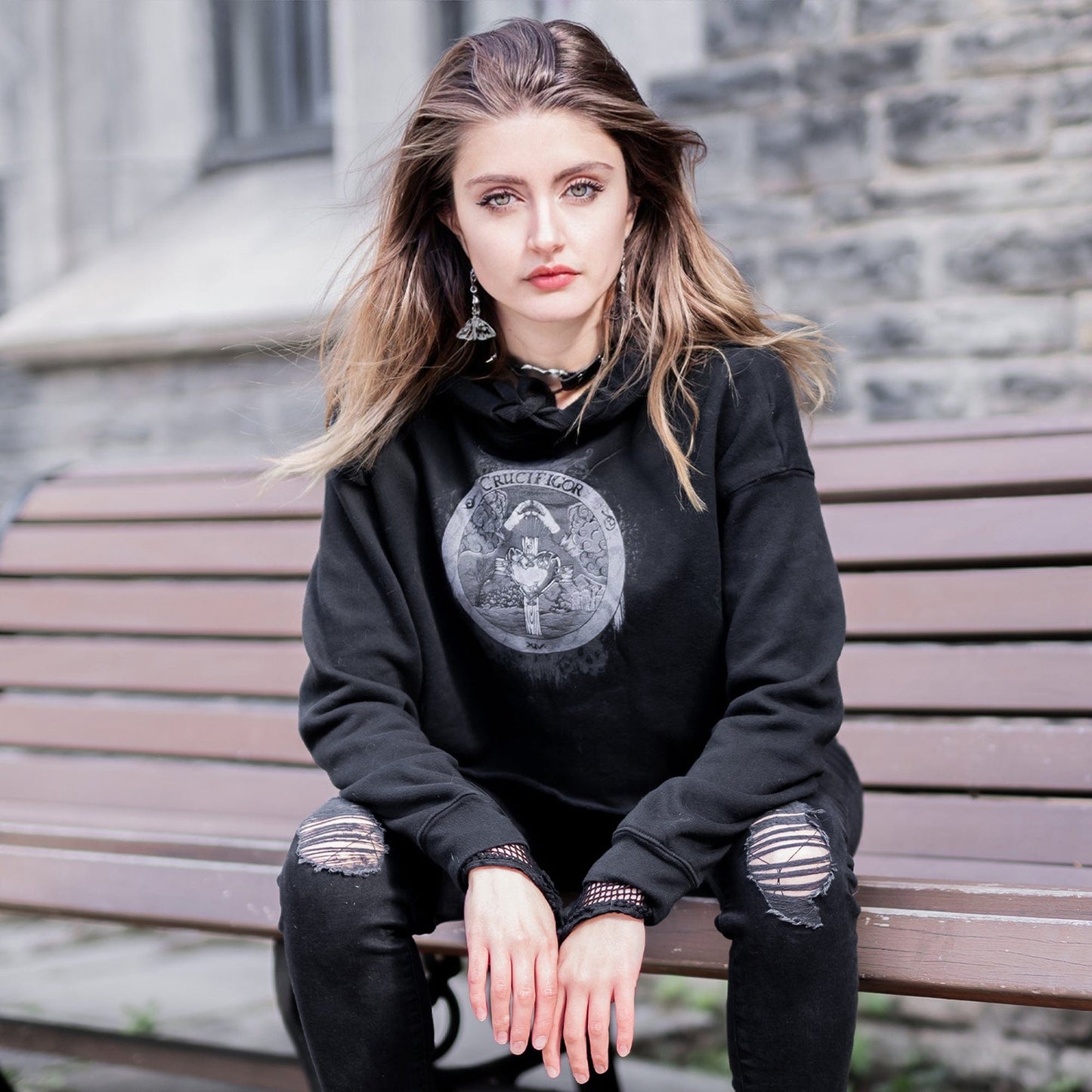 Model wearing Illuminor Crop Hoodie in a gothic setting from Mr. Serial Killer