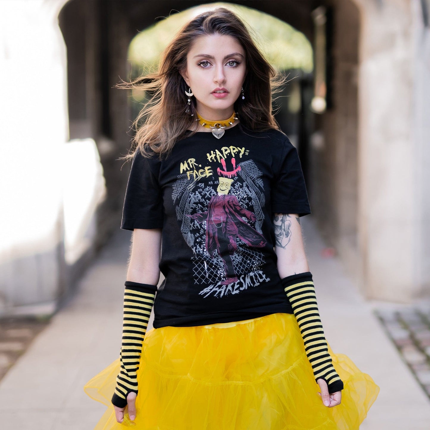 Gothic model wearing Mr. Happy Face Graphic T-Shirt in a Victorian setting