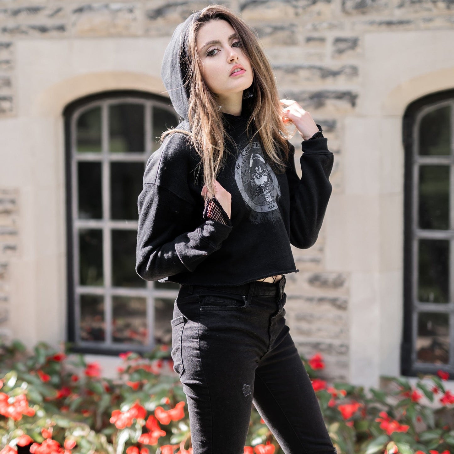 Model wearing Illuminor Crop Hoodie in a gothic setting from Mr. Serial Killer