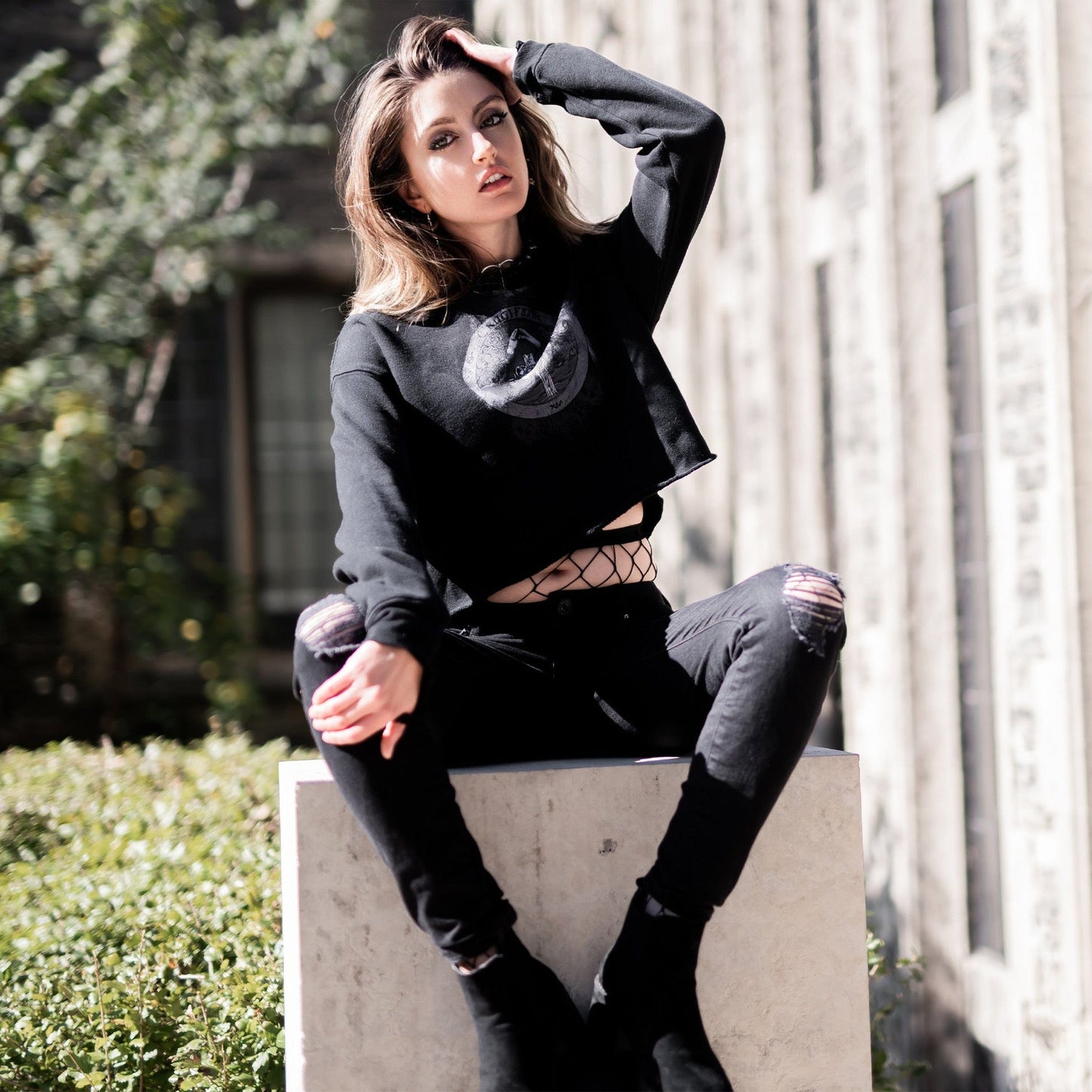 Model wearing Illuminor Crop Hoodie in a gothic setting from Mr. Serial Killer