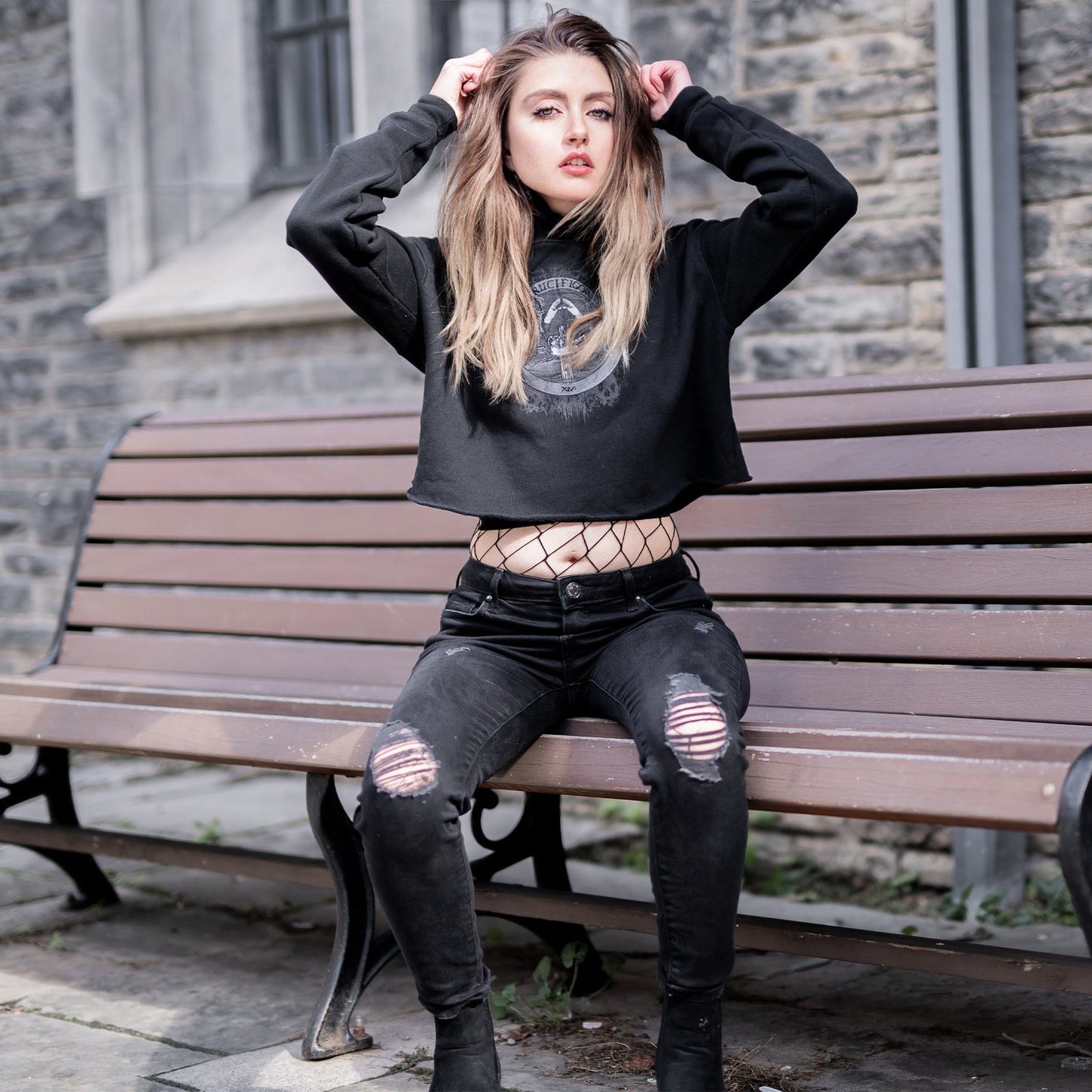Model wearing Illuminor Crop Hoodie in a gothic setting from Mr. Serial Killer