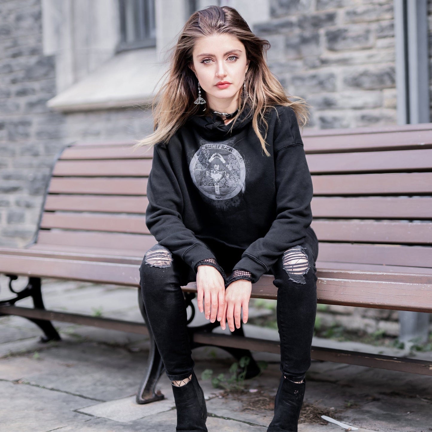 Model wearing Illuminor Crop Hoodie in a gothic setting from Mr. Serial Killer