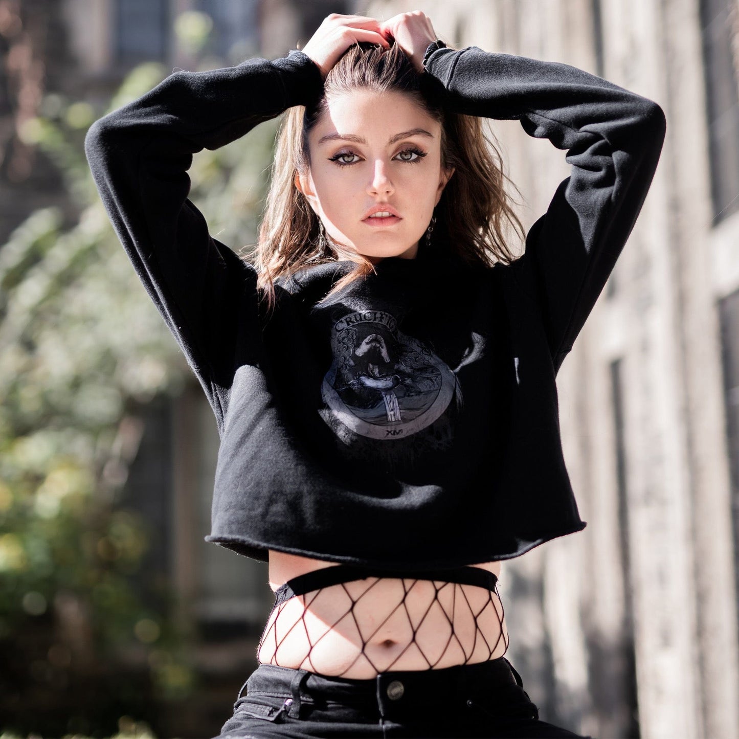 Model wearing Illuminor Crop Hoodie in a gothic setting from Mr. Serial Killer