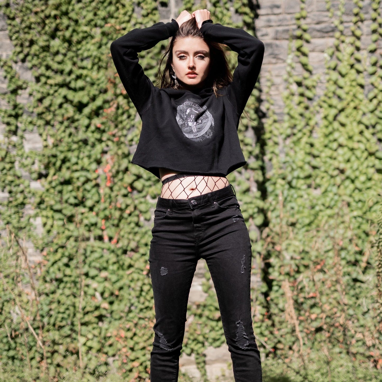 Model wearing Illuminor Crop Hoodie in a gothic setting from Mr. Serial Killer