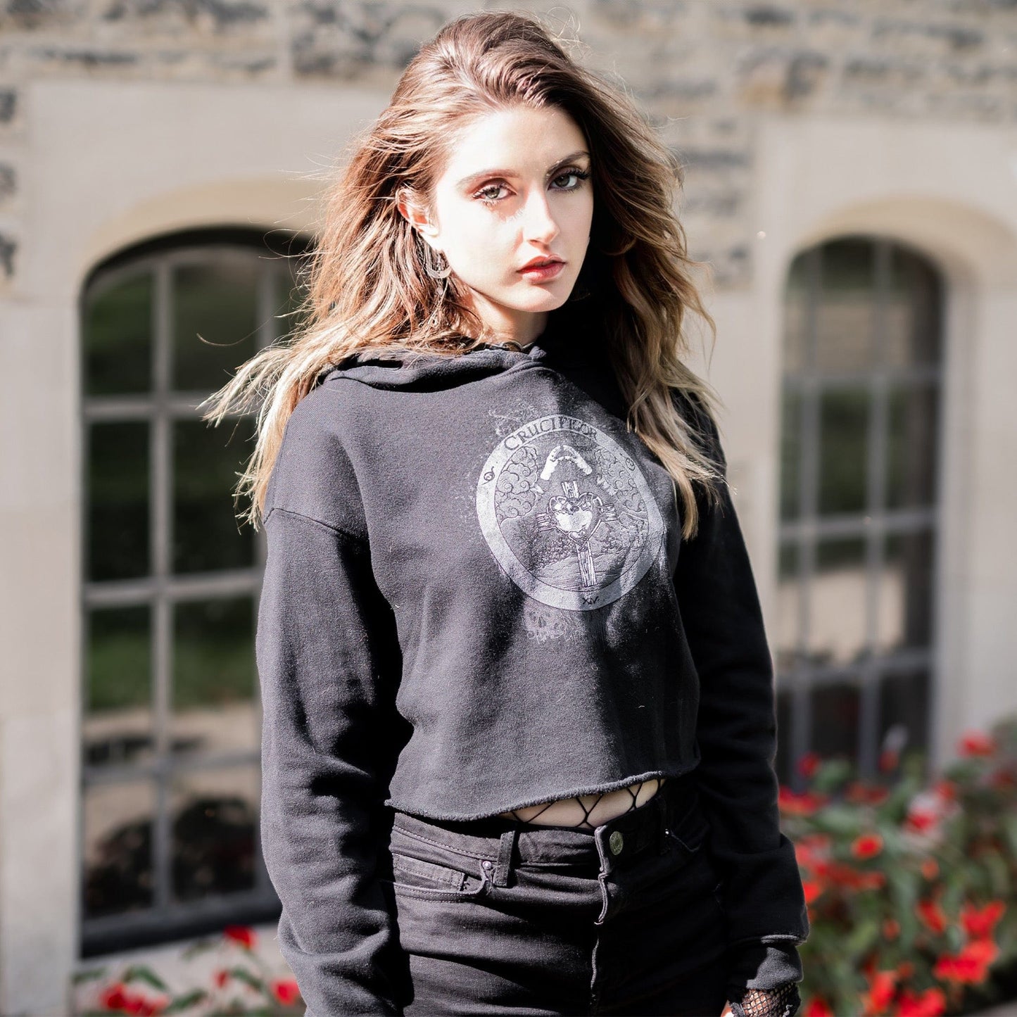 Model wearing Illuminor Crop Hoodie in a gothic setting from Mr. Serial Killer