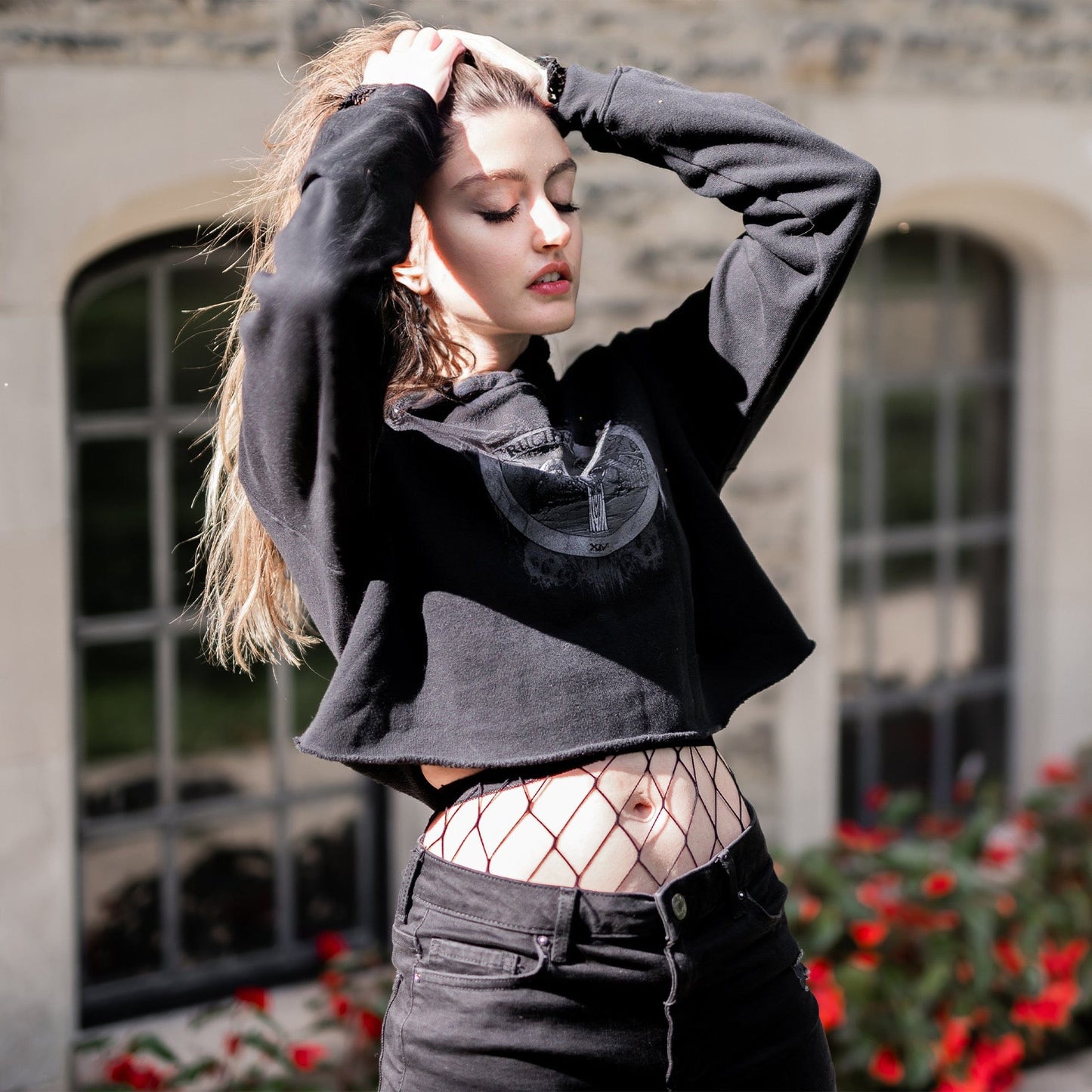 Model wearing Illuminor Crop Hoodie in a gothic setting from Mr. Serial Killer