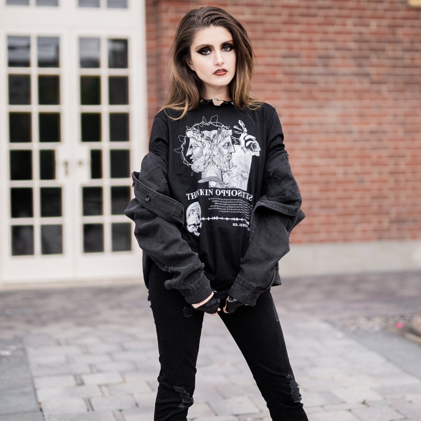 Model wearing Head of Janus Graphic T-Shirt in a gothic setting from Mr. Serial Killer's Shop