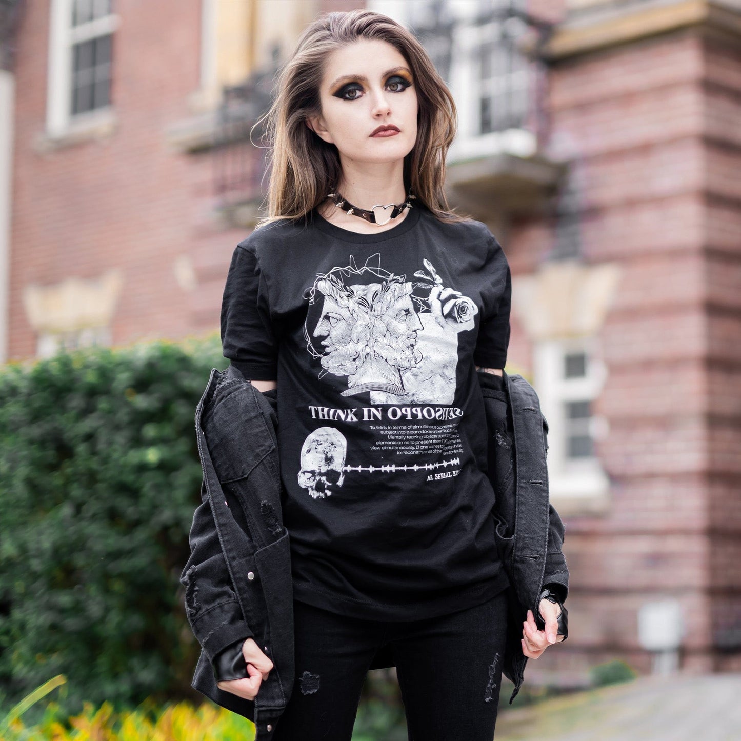 Model wearing Head of Janus Graphic T-Shirt in a gothic setting from Mr. Serial Killer's Shop