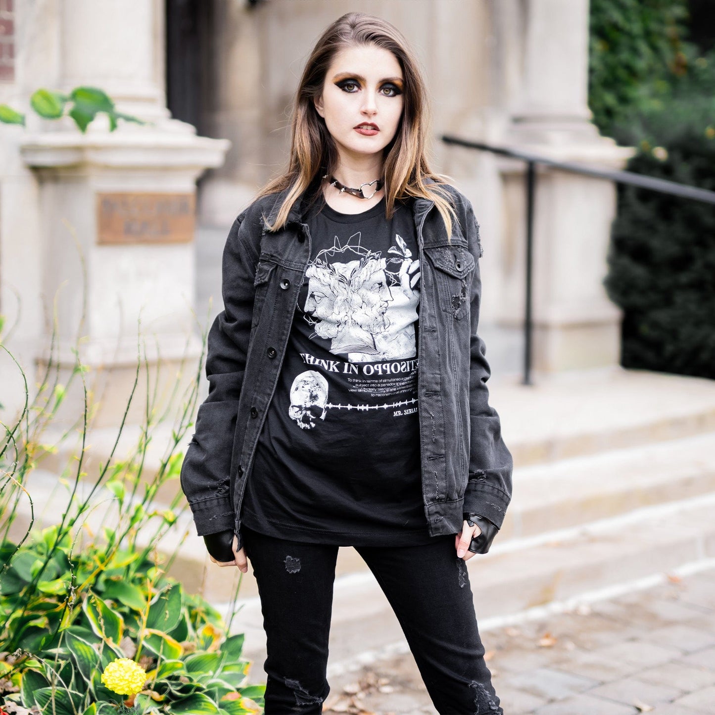 Model wearing Head of Janus Graphic T-Shirt in a gothic setting from Mr. Serial Killer's Shop