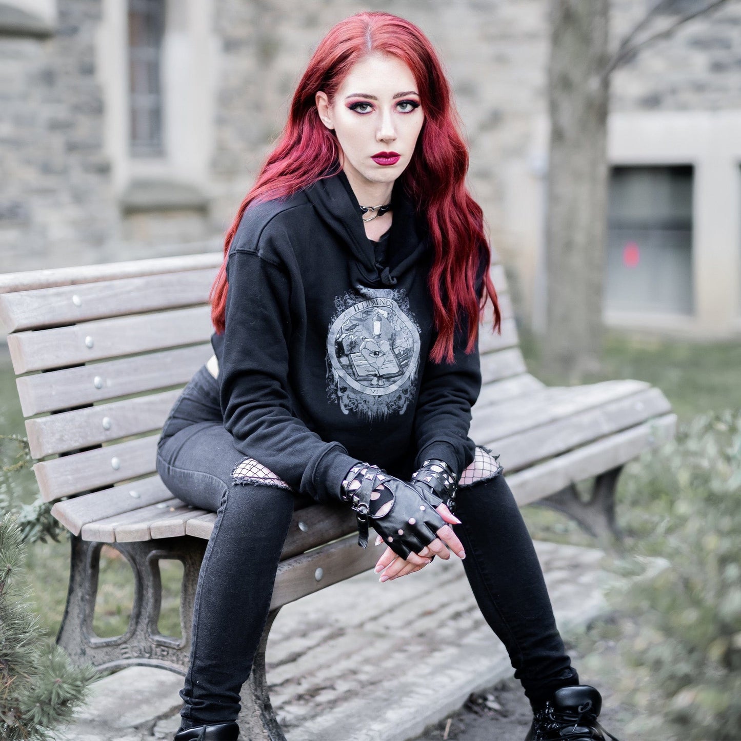 Model wearing Illuminor Crop Hoodie in a gothic setting by Mr. Serial Killer