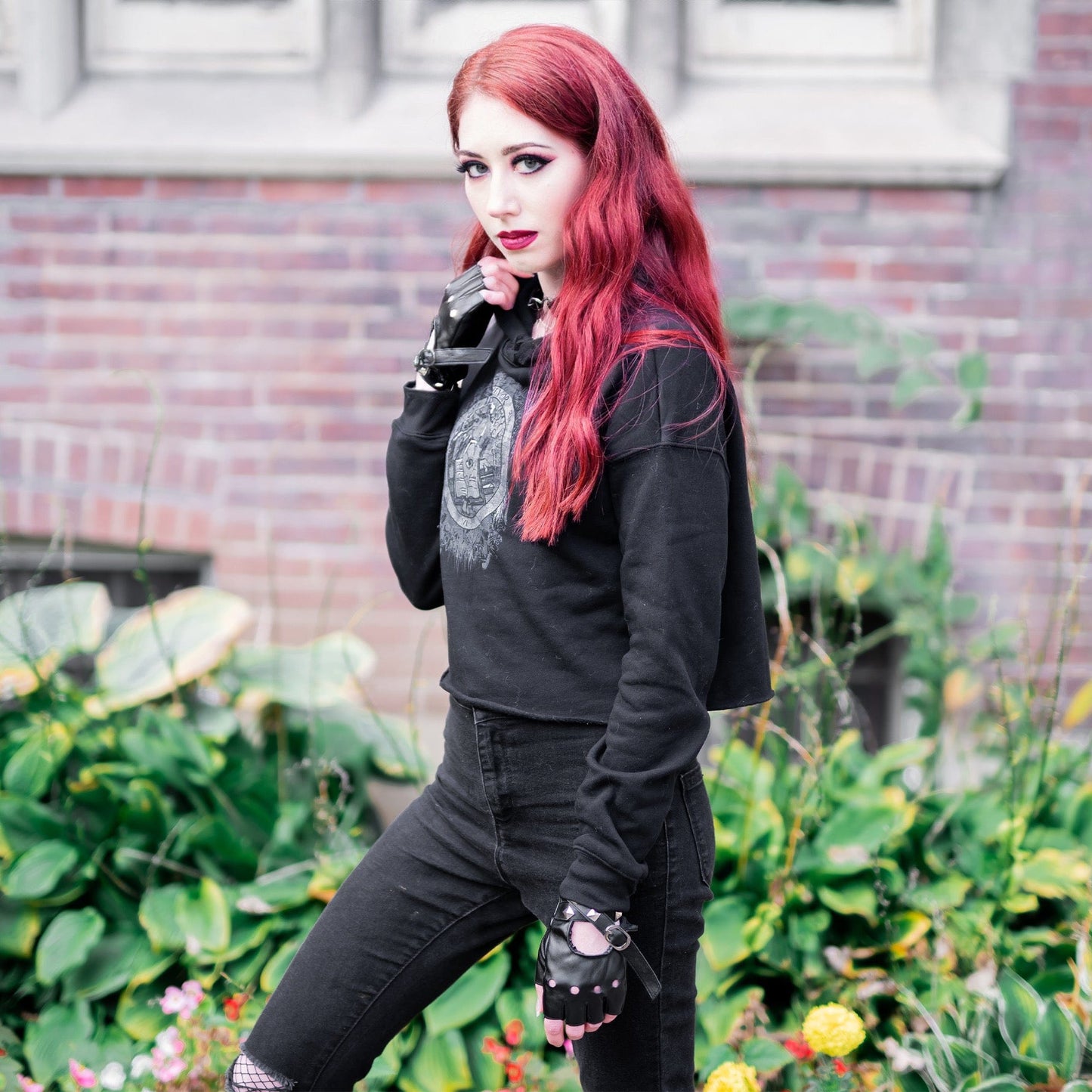 Model wearing Illuminor Crop Hoodie in a gothic setting by Mr. Serial Killer