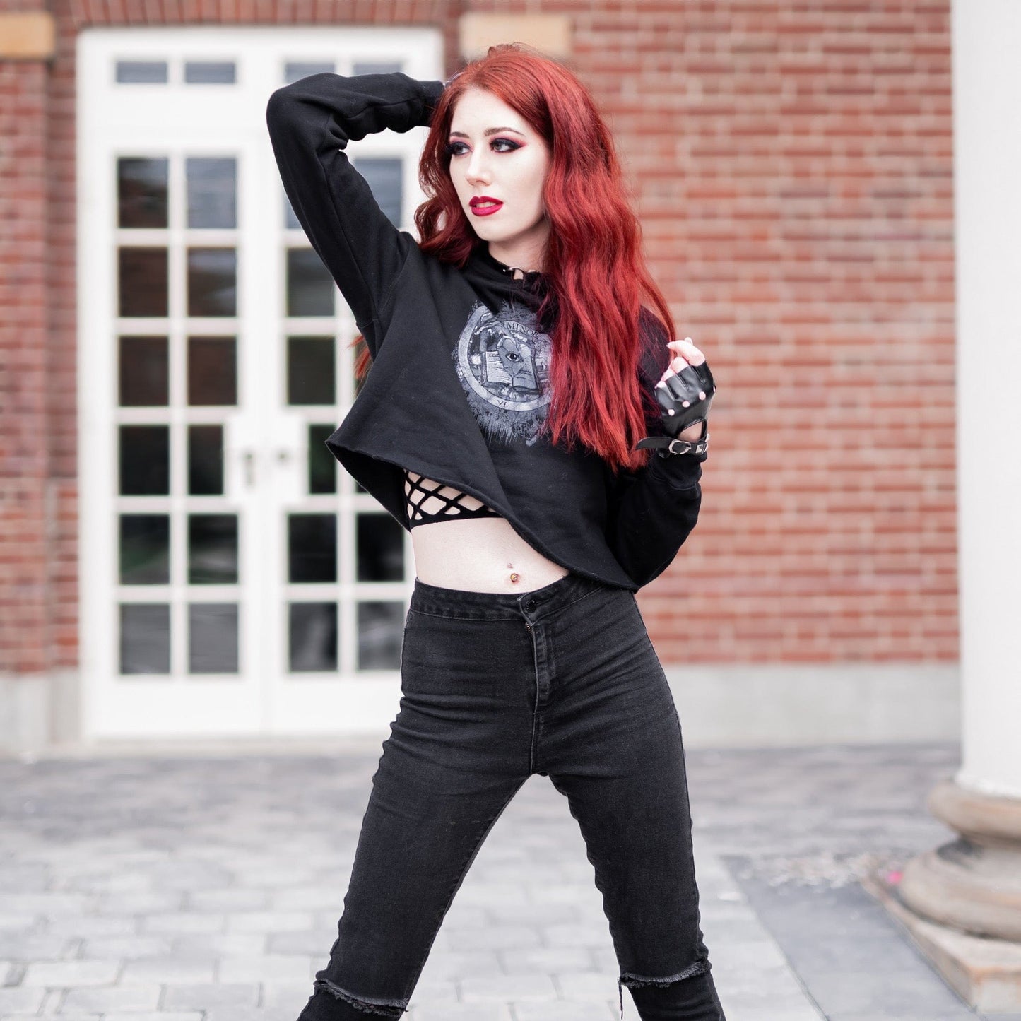 Model wearing Illuminor Crop Hoodie in a gothic setting by Mr. Serial Killer