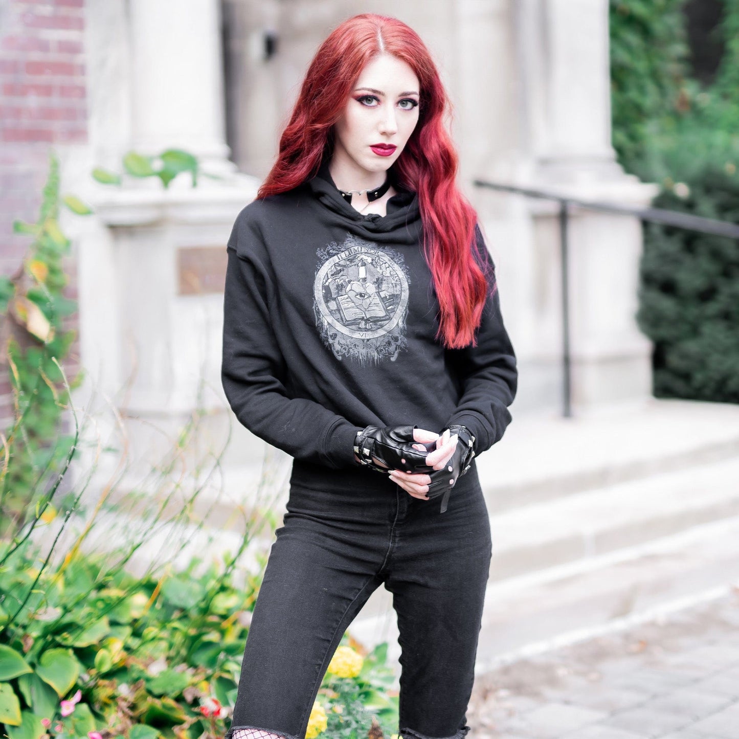 Model wearing Illuminor Crop Hoodie in a gothic setting by Mr. Serial Killer