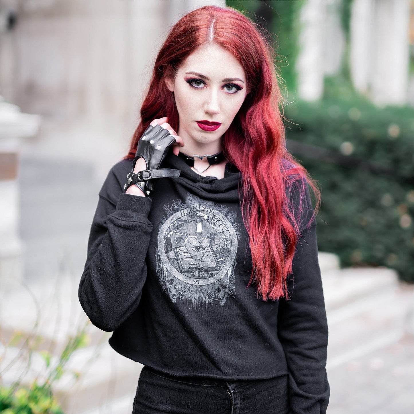 Model wearing Illuminor Crop Hoodie in a gothic setting by Mr. Serial Killer