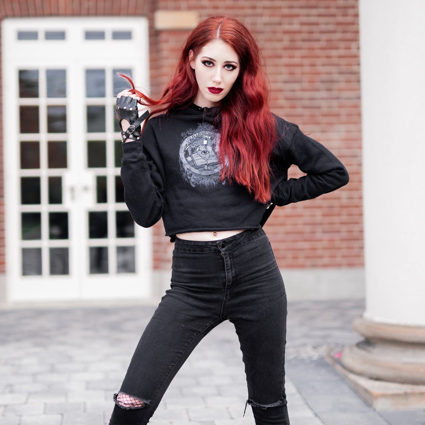 Model wearing Illuminor Crop Hoodie in a gothic setting by Mr. Serial Killer