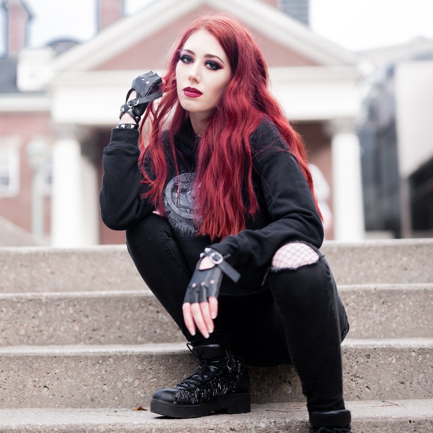 Model wearing Illuminor Crop Hoodie in a gothic setting by Mr. Serial Killer