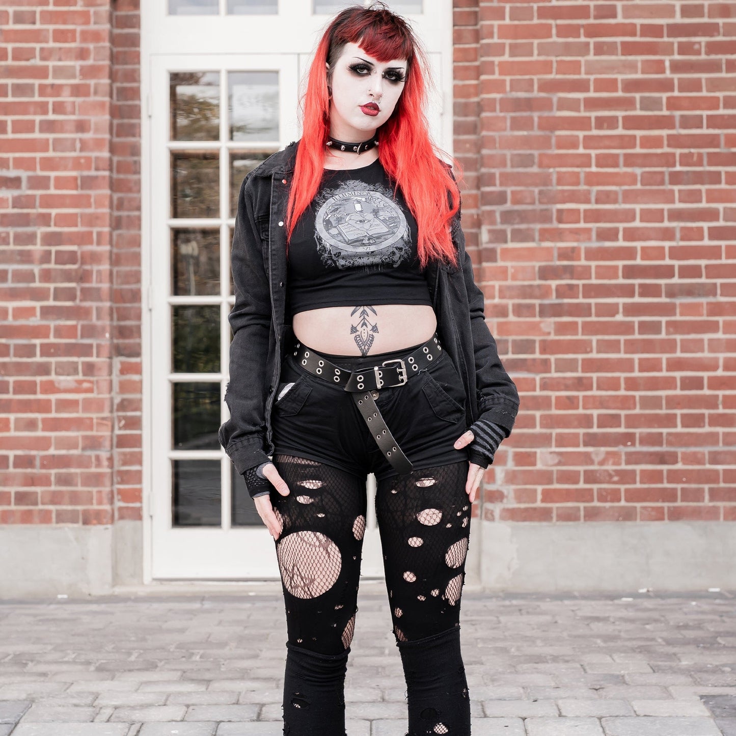 Model wearing Illuminor Graphic Crop Top in a gothic setting from Mr. Serial Killer