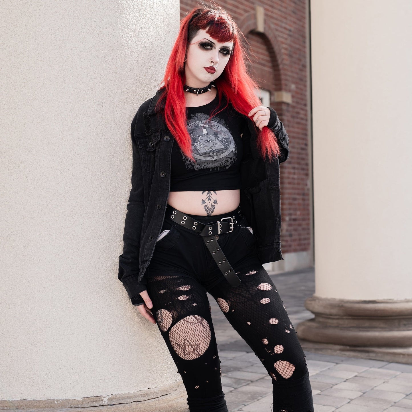 Model wearing Illuminor Graphic Crop Top in a gothic setting from Mr. Serial Killer