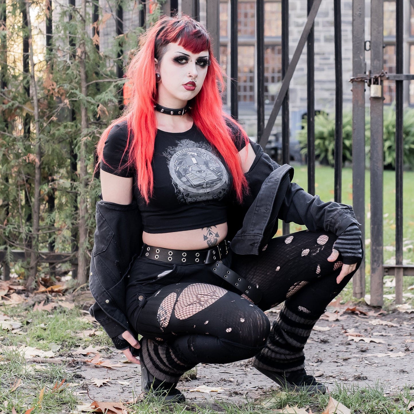 Model wearing Illuminor Graphic Crop Top in a gothic setting from Mr. Serial Killer