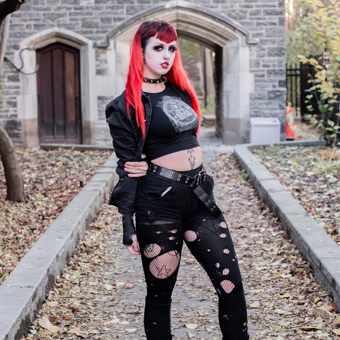 Model wearing Illuminor Graphic Crop Top in a gothic setting from Mr. Serial Killer