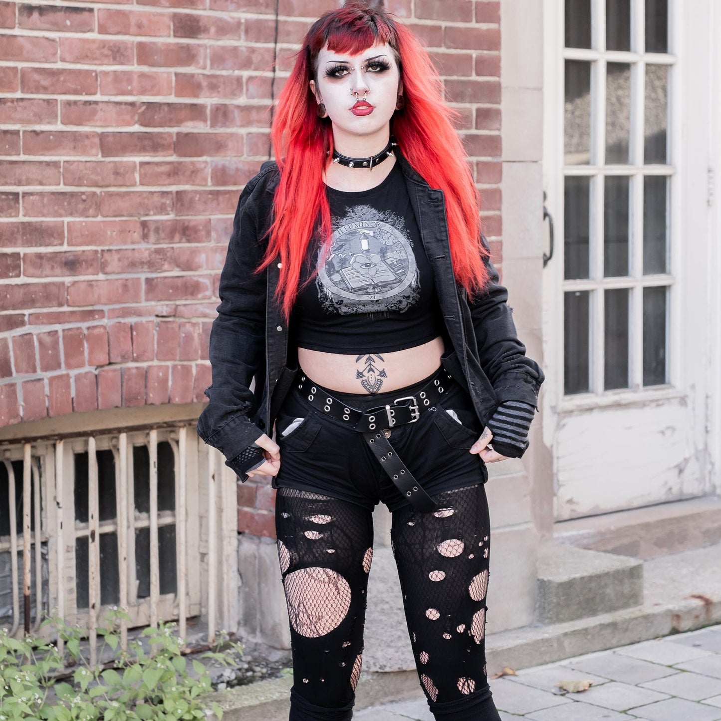 Model wearing Illuminor Graphic Crop Top in a gothic setting from Mr. Serial Killer