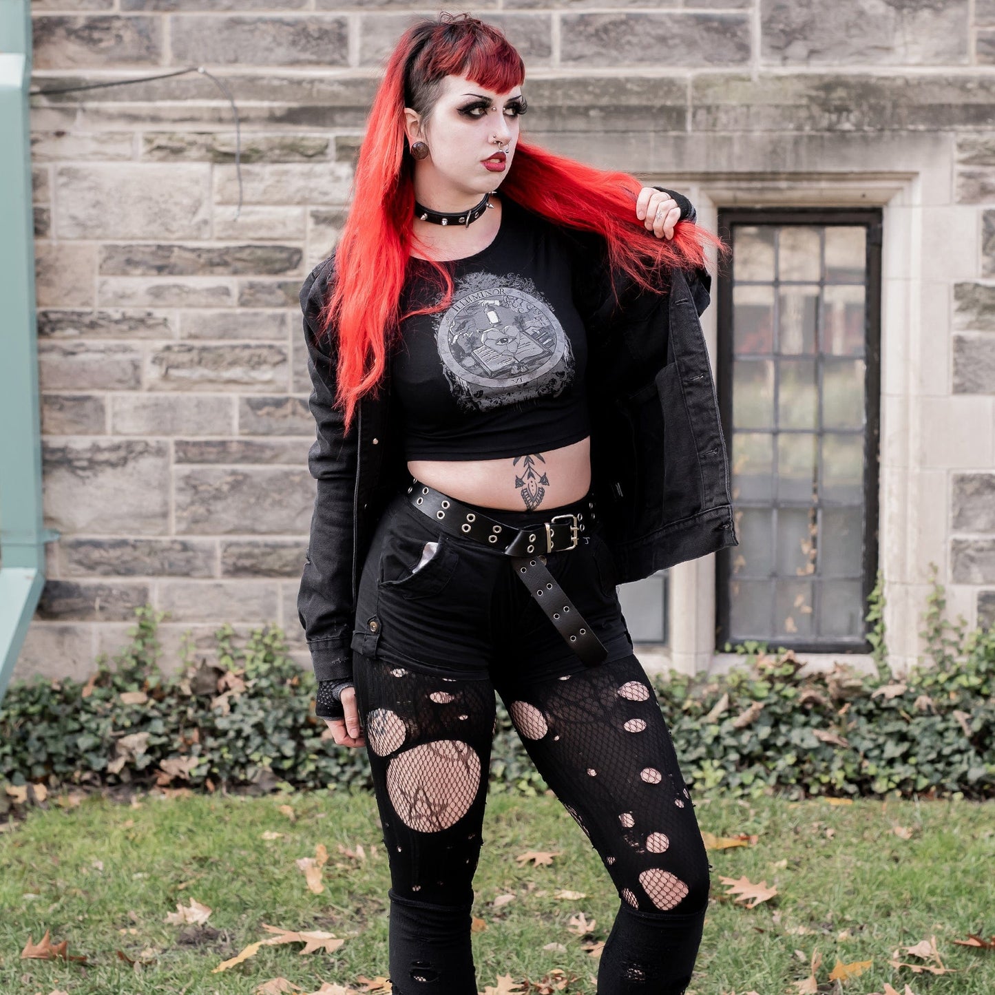 Model wearing Illuminor Graphic Crop Top in a gothic setting from Mr. Serial Killer