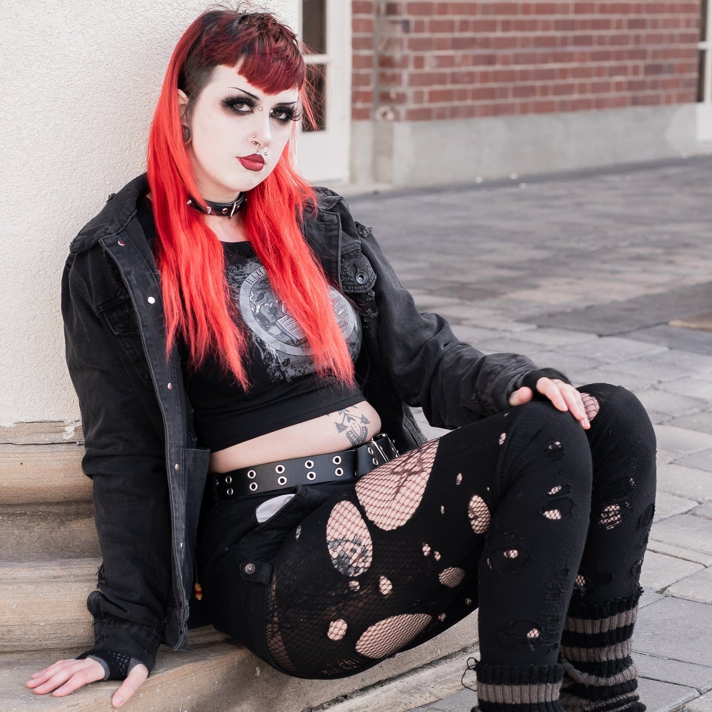 Model wearing Illuminor Graphic Crop Top in a gothic setting from Mr. Serial Killer