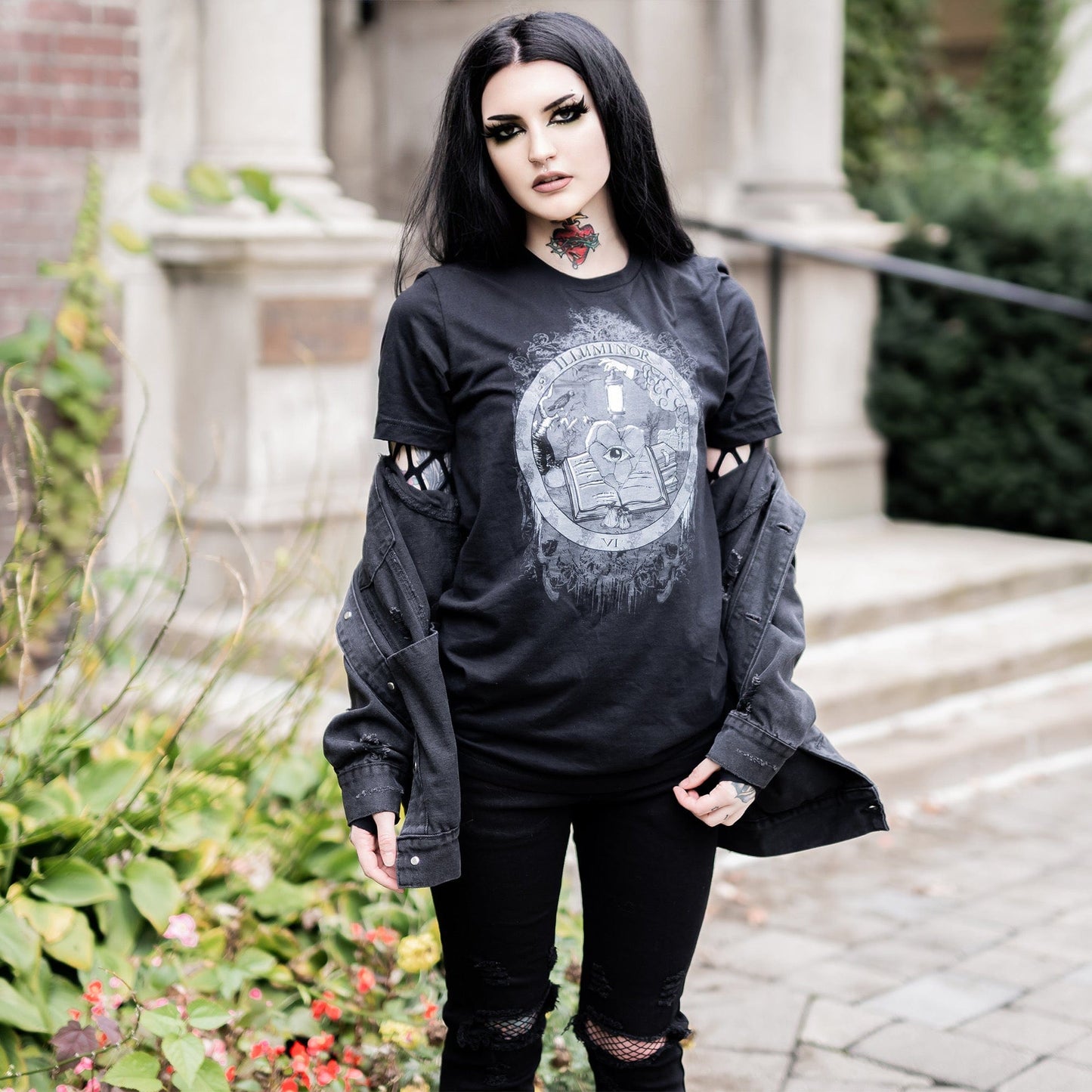 Model wearing Illuminor Graphic T-Shirt in a gothic setting from Mr. Serial Killer