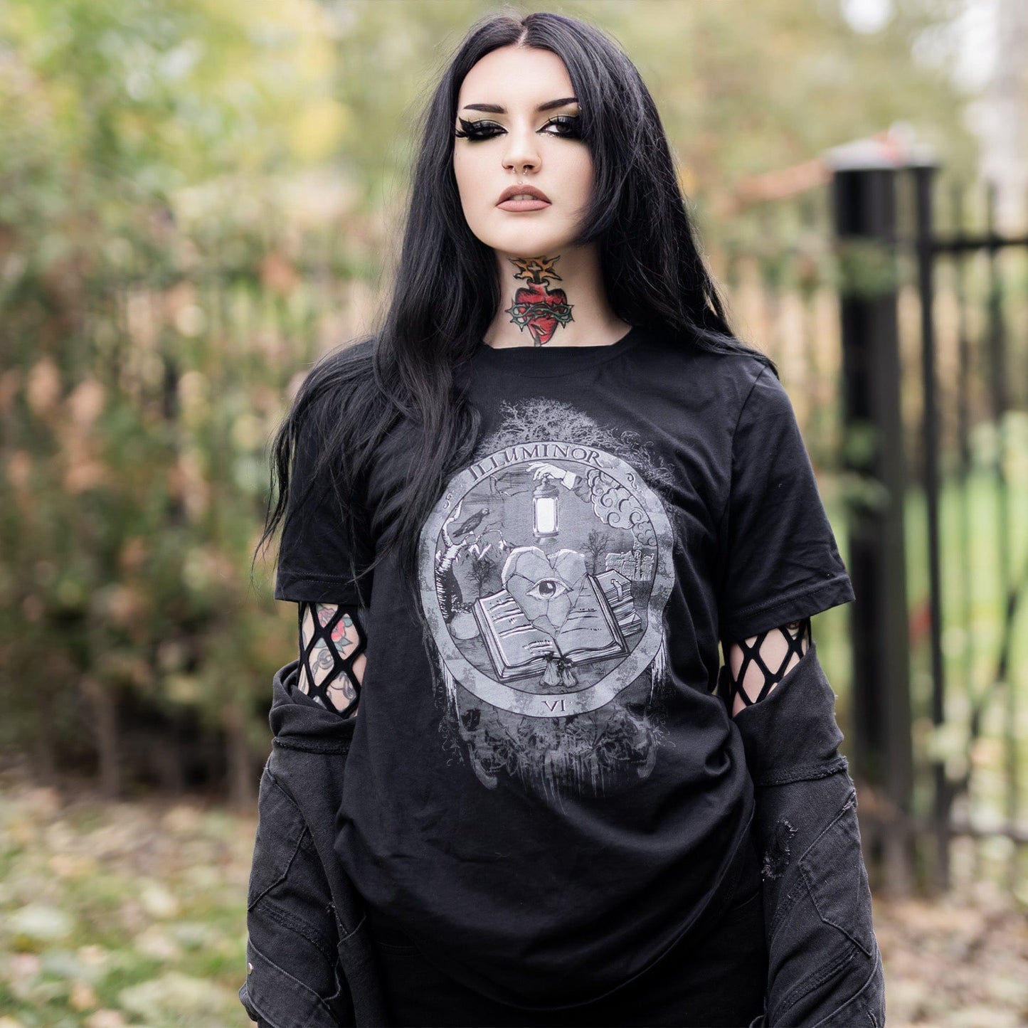 Model wearing Illuminor Graphic T-Shirt in a gothic setting from Mr. Serial Killer