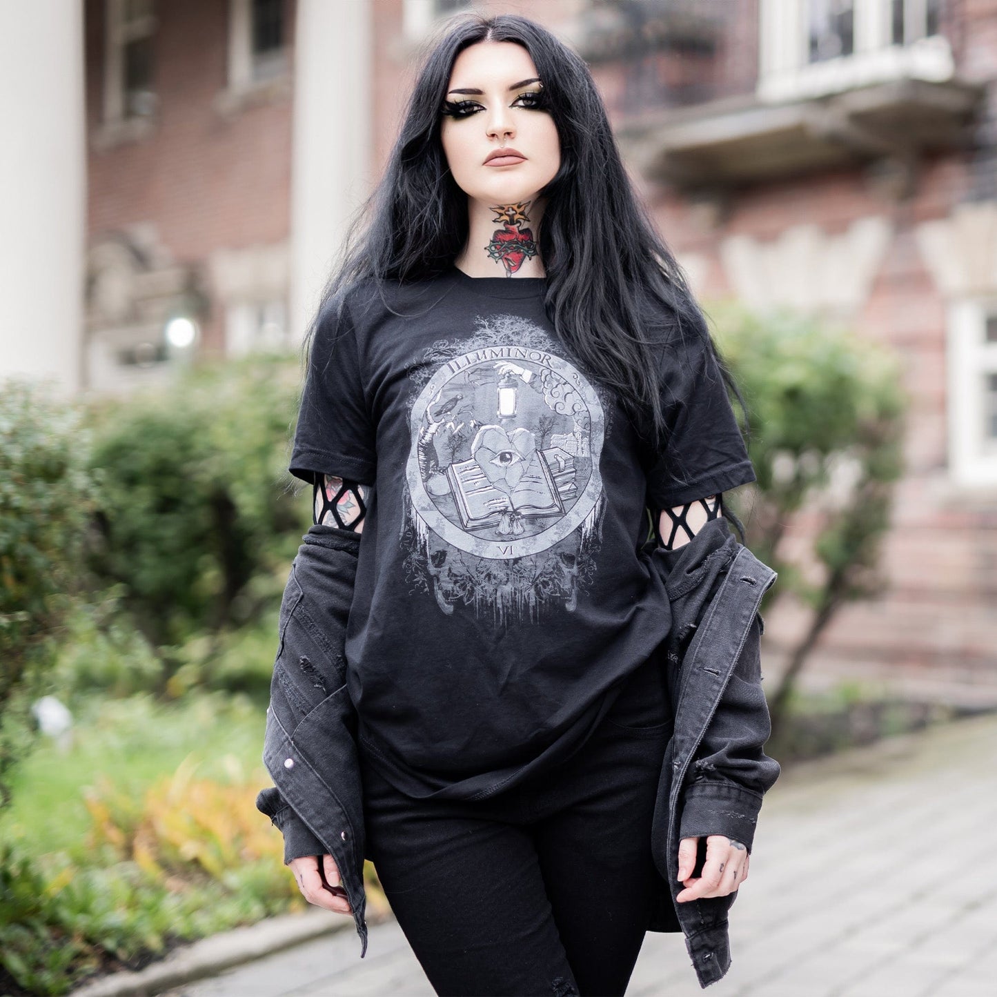Model wearing Illuminor Graphic T-Shirt in a gothic setting from Mr. Serial Killer