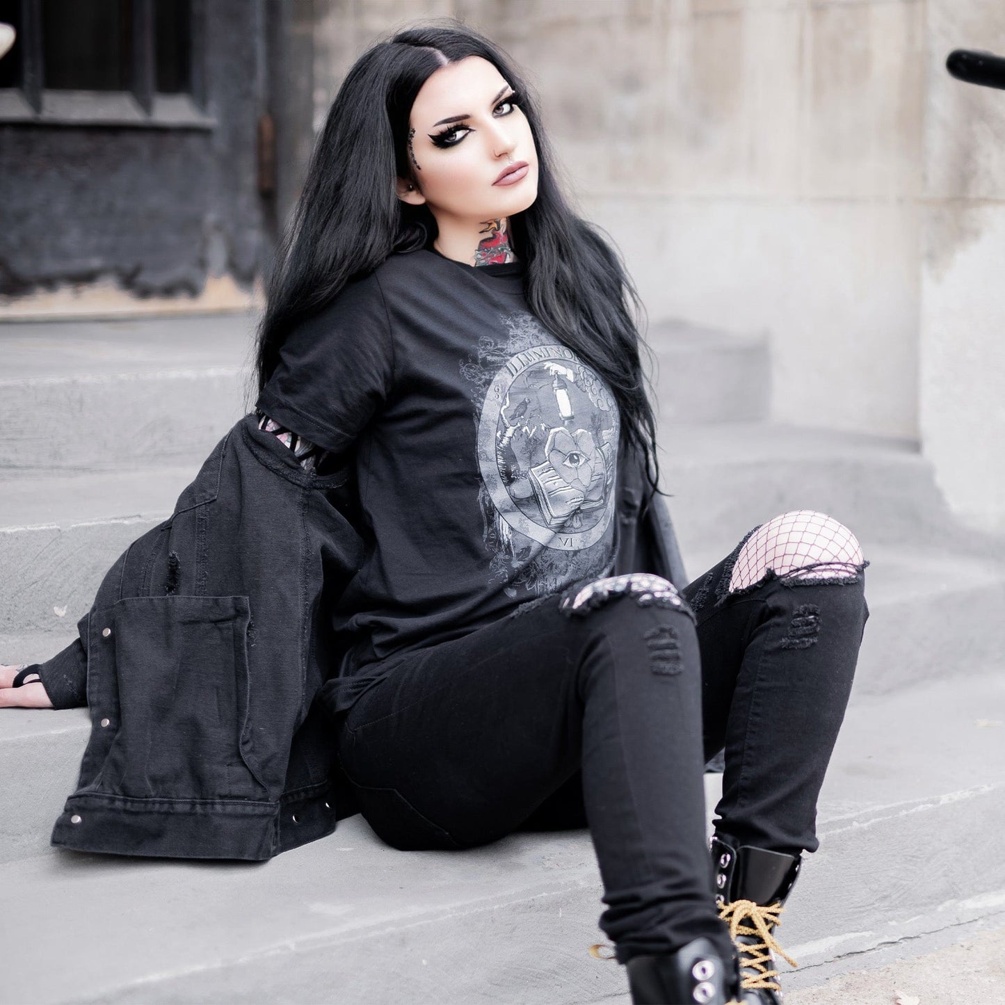 Model wearing Illuminor Graphic T-Shirt in a gothic setting from Mr. Serial Killer