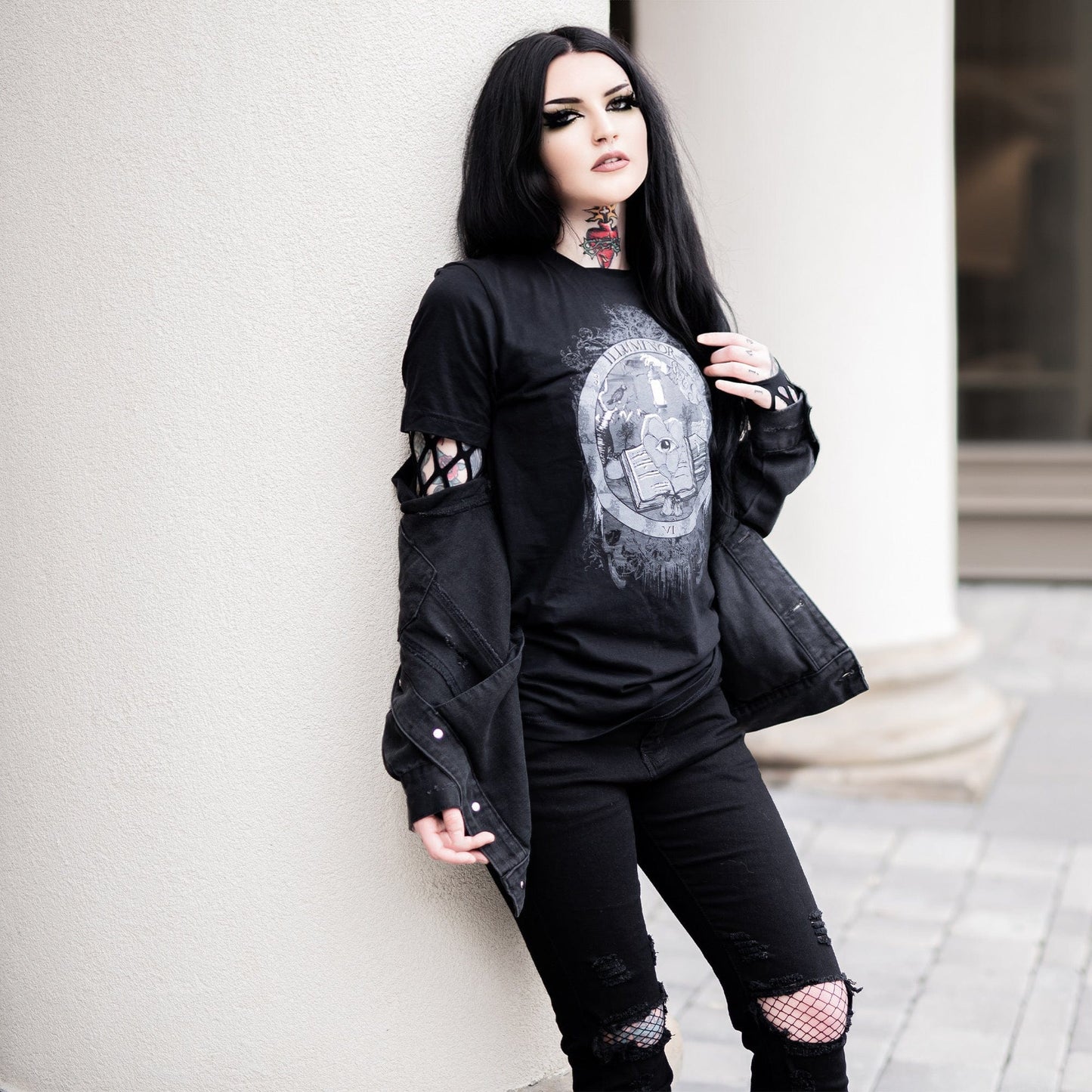 Model wearing Illuminor Graphic T-Shirt in a gothic setting from Mr. Serial Killer