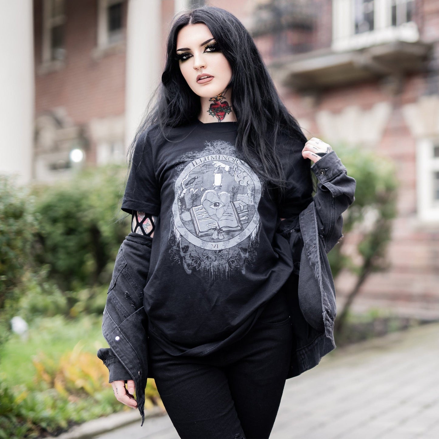 Model wearing Illuminor Graphic T-Shirt in a gothic setting from Mr. Serial Killer