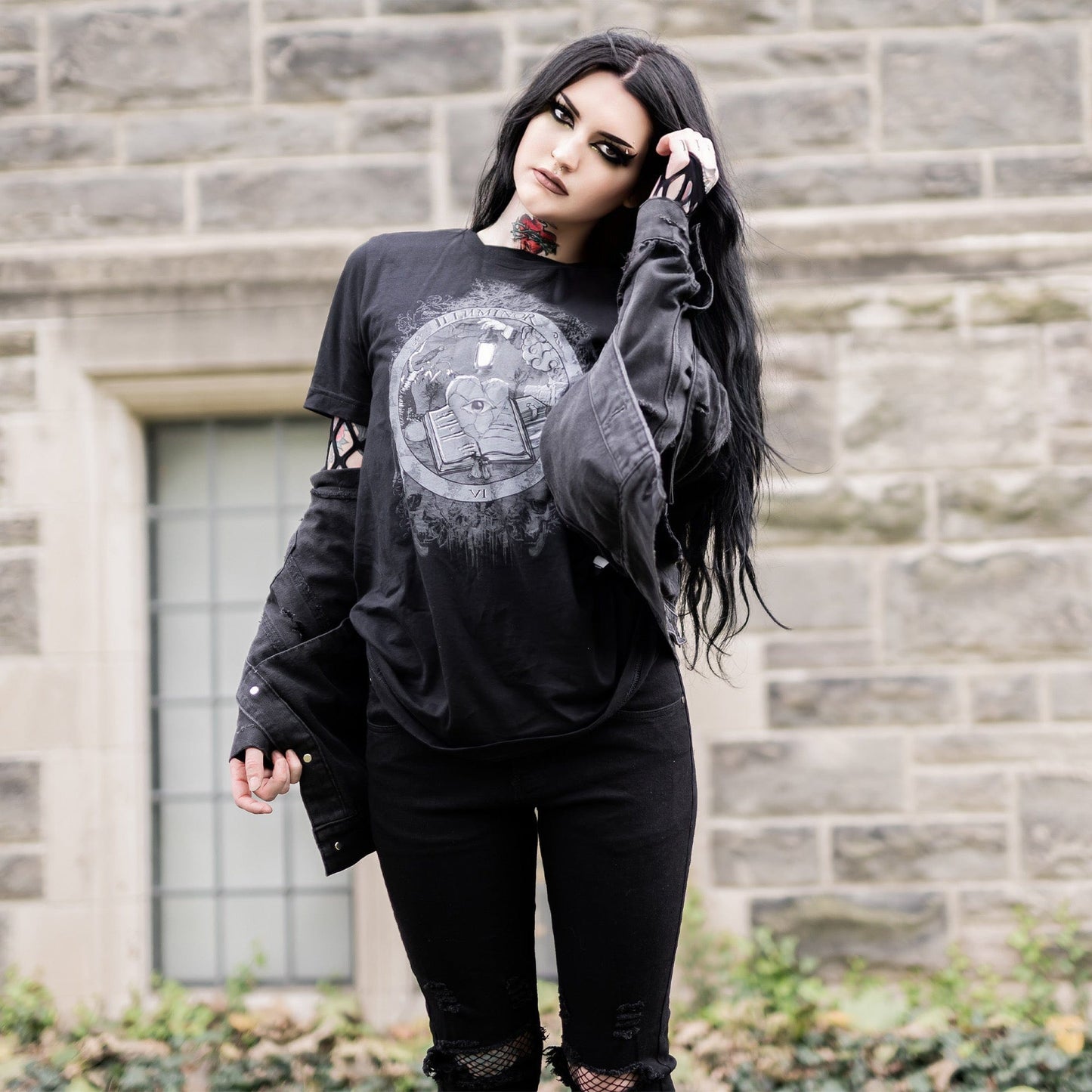 Model wearing Illuminor Graphic T-Shirt in a gothic setting from Mr. Serial Killer