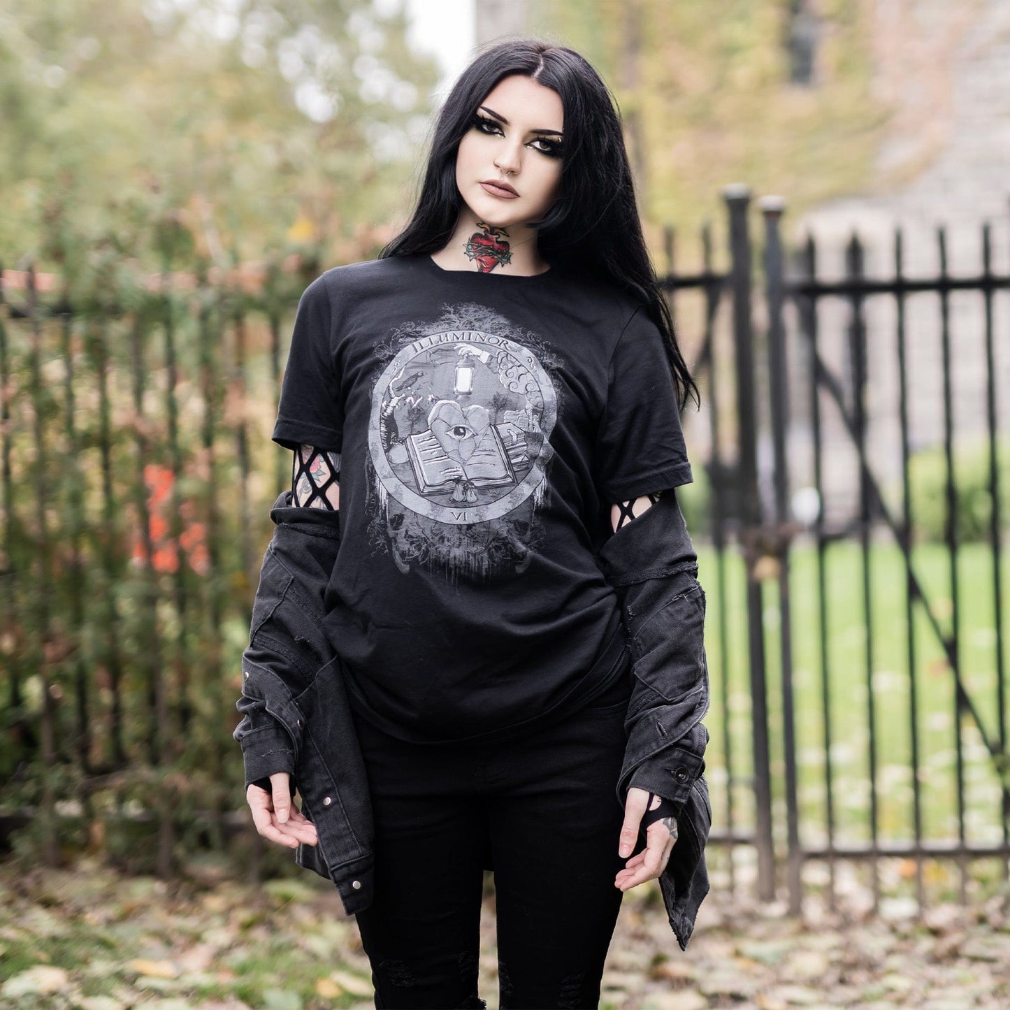 Model wearing Illuminor Graphic T-Shirt in a gothic setting from Mr. Serial Killer