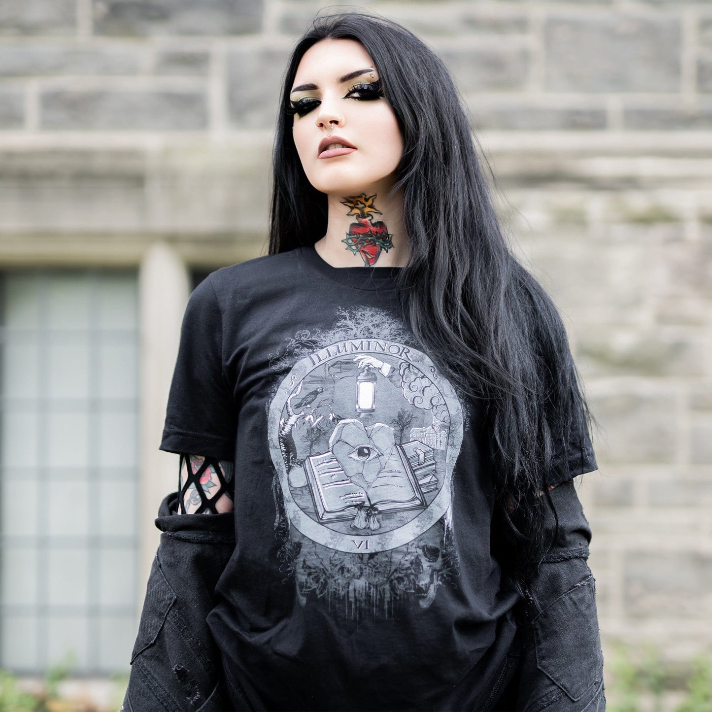 Model wearing Illuminor Graphic T-Shirt in a gothic setting from Mr. Serial Killer