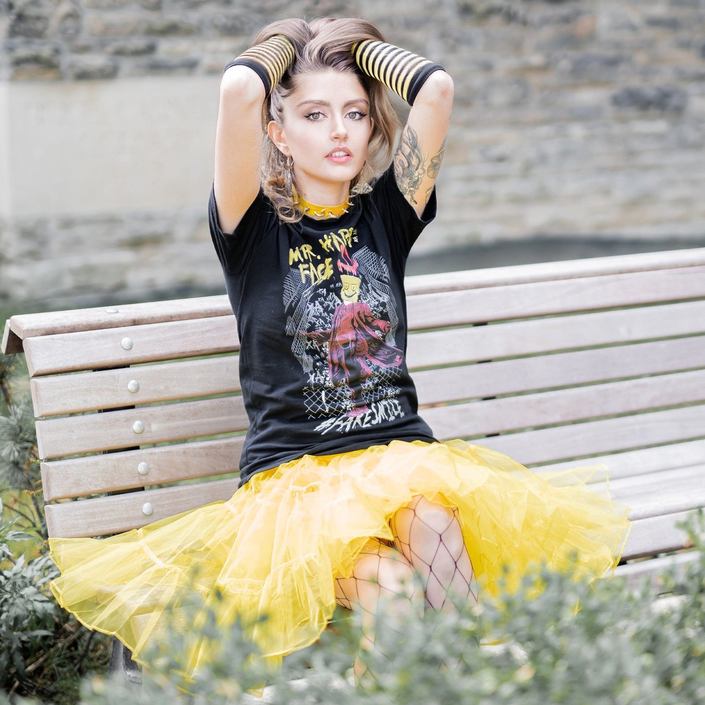 Gothic model wearing Mr. Happy Face Graphic T-Shirt in a Victorian setting