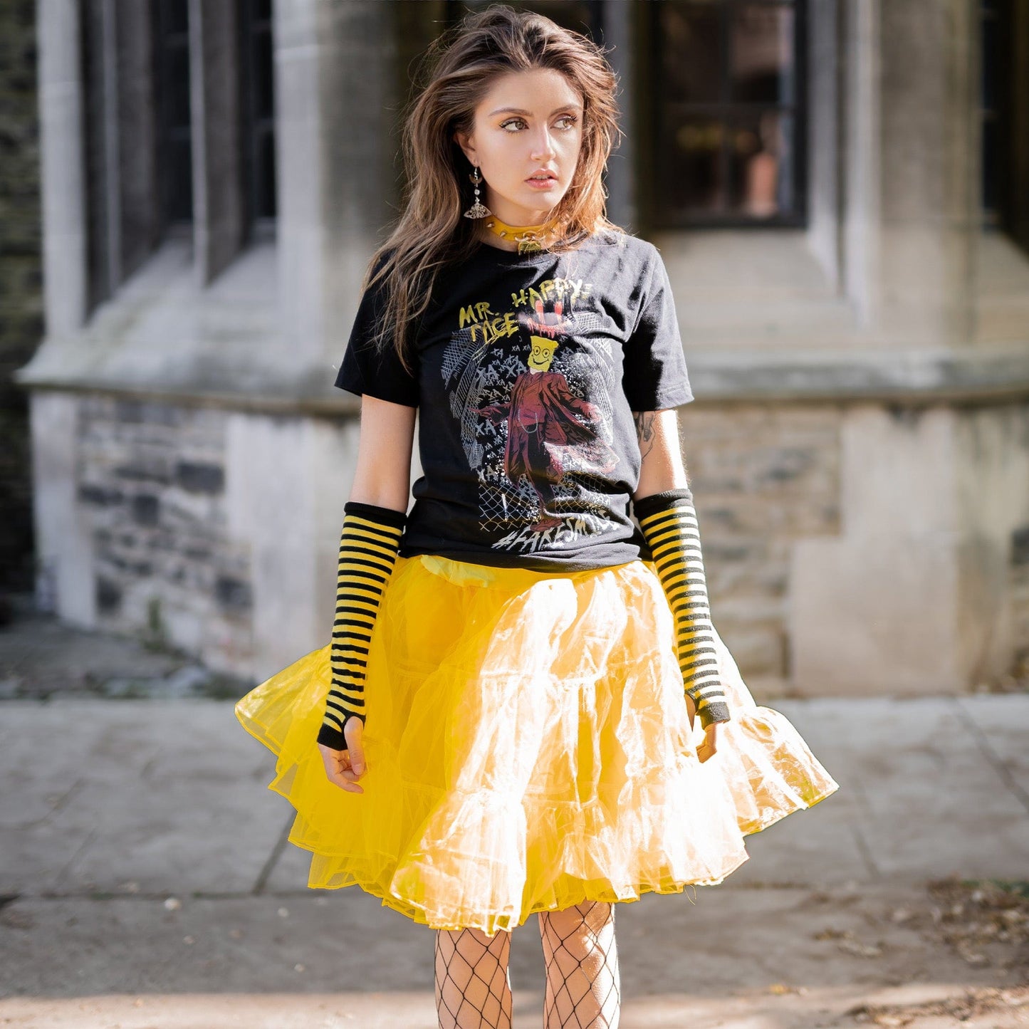 Gothic model wearing Mr. Happy Face Graphic T-Shirt in a Victorian setting