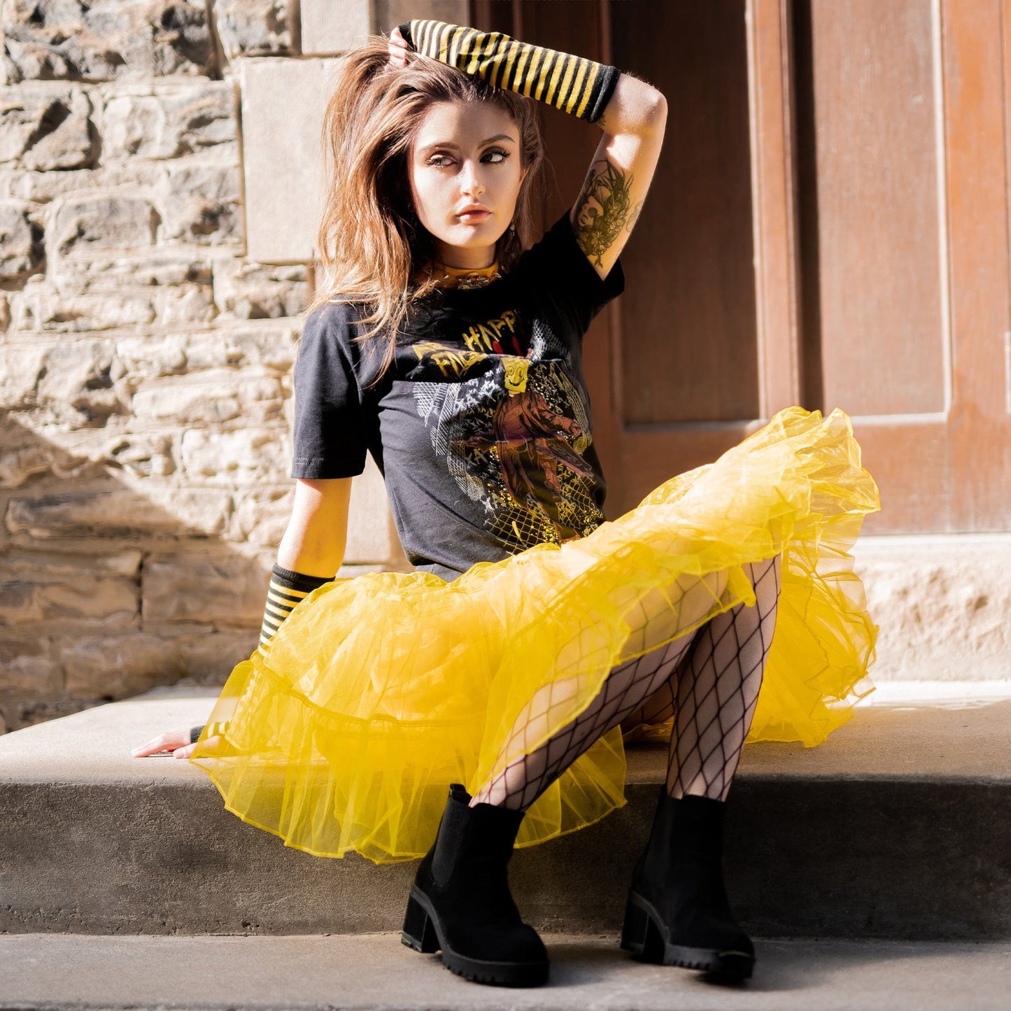Gothic model wearing Mr. Happy Face Graphic T-Shirt in a Victorian setting