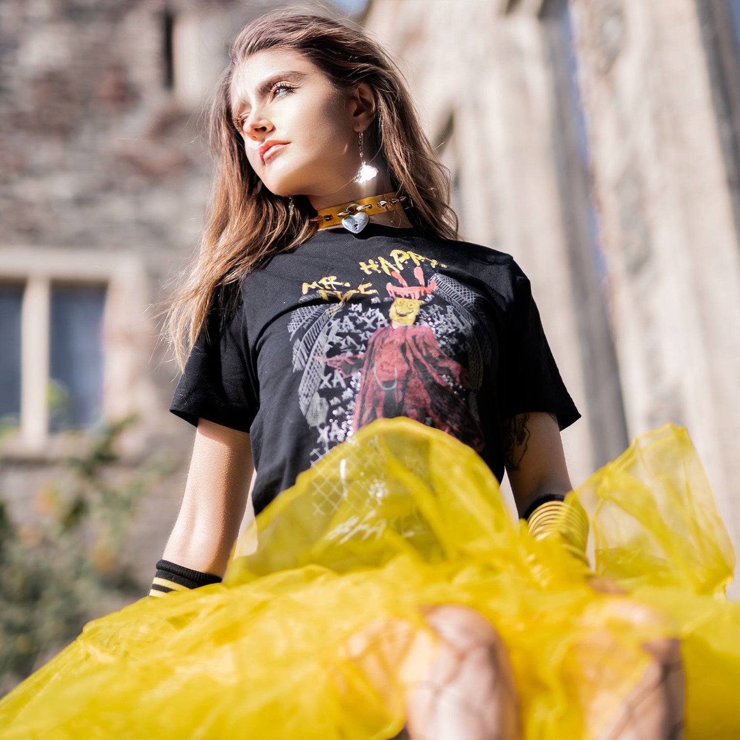 Gothic model wearing Mr. Happy Face Graphic T-Shirt in a Victorian setting