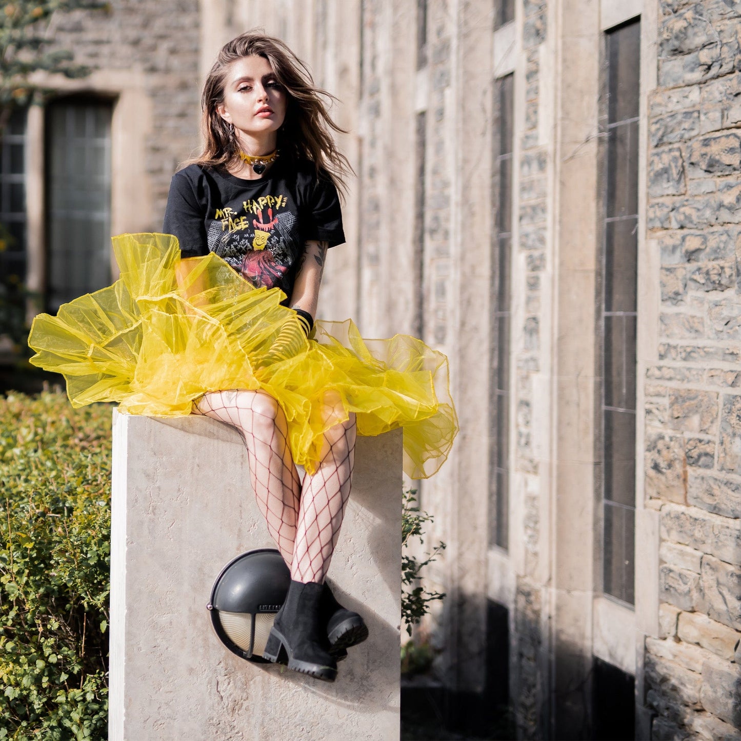 Gothic model wearing Mr. Happy Face Graphic T-Shirt in a Victorian setting