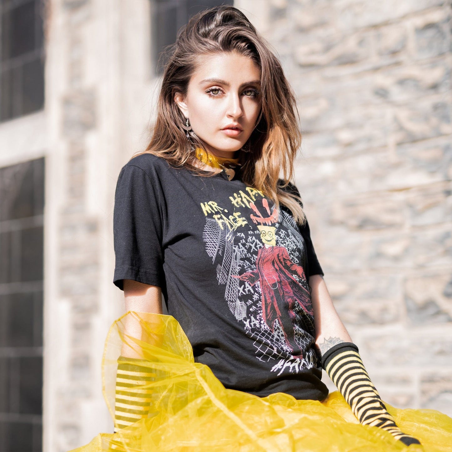 Gothic model wearing Mr. Happy Face Graphic T-Shirt in a Victorian setting