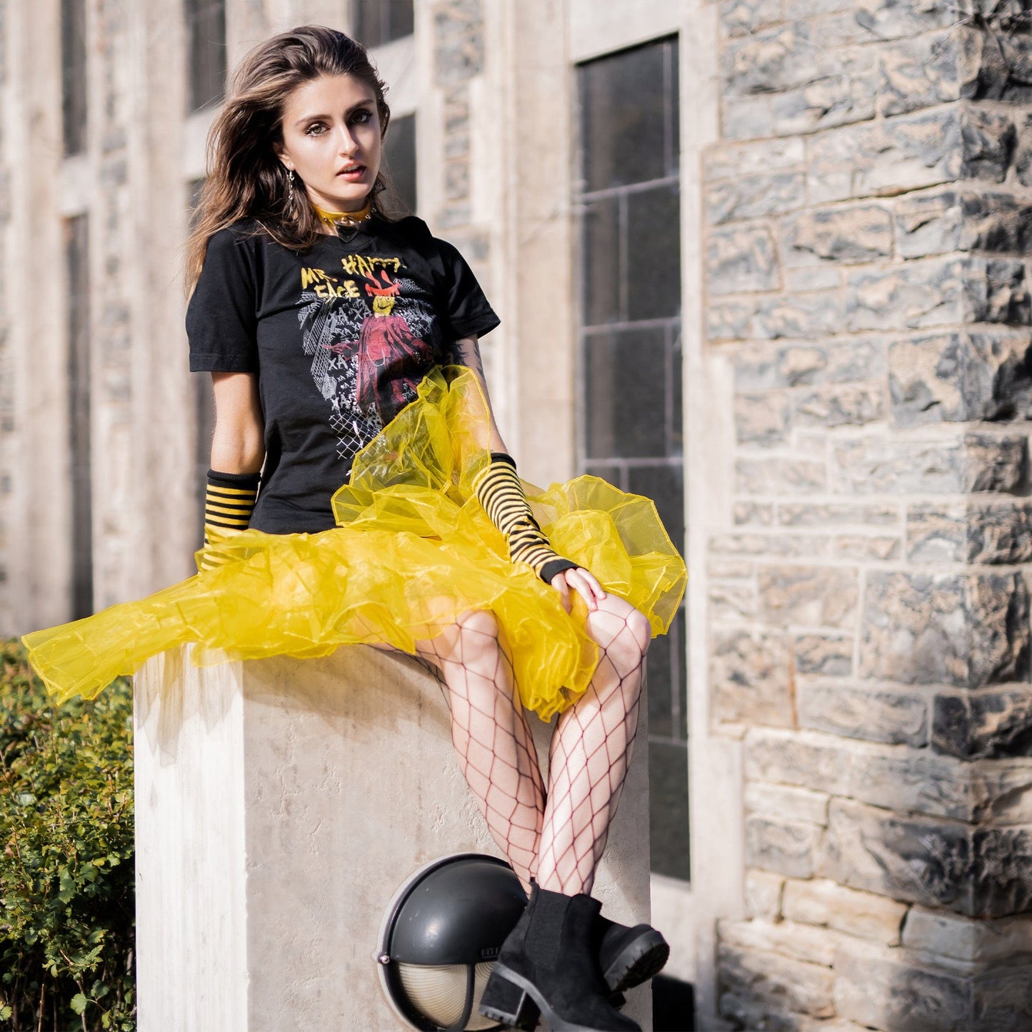 Gothic model wearing Mr. Happy Face Graphic T-Shirt in a Victorian setting