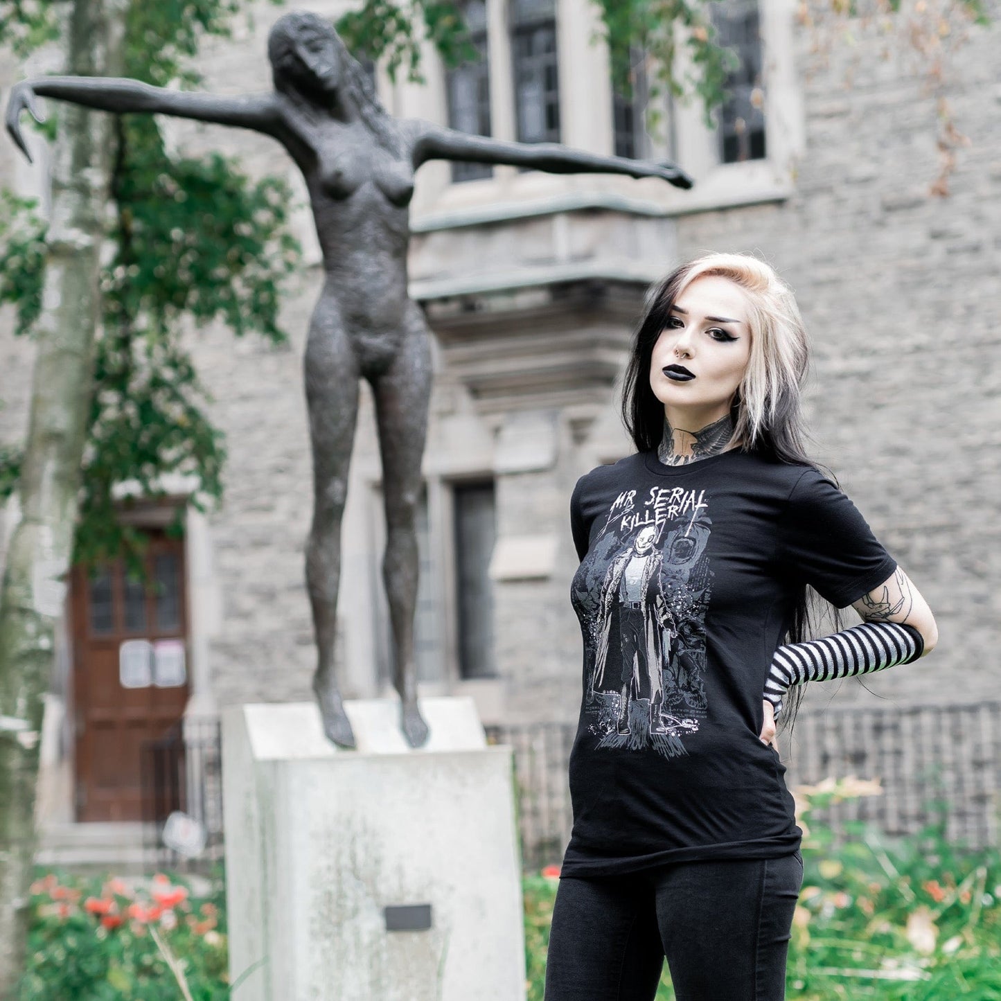 Gothic model wearing the Mr. Serial Killer Follow Your Shadow Graphic T-Shirt in a Victorian setting, capturing dark macabre fashion