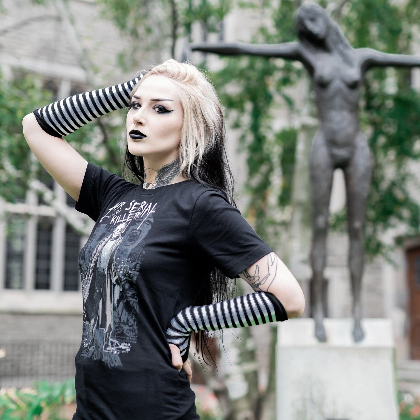 Gothic model wearing the Mr. Serial Killer Follow Your Shadow Graphic T-Shirt in a Victorian setting, capturing dark macabre fashion