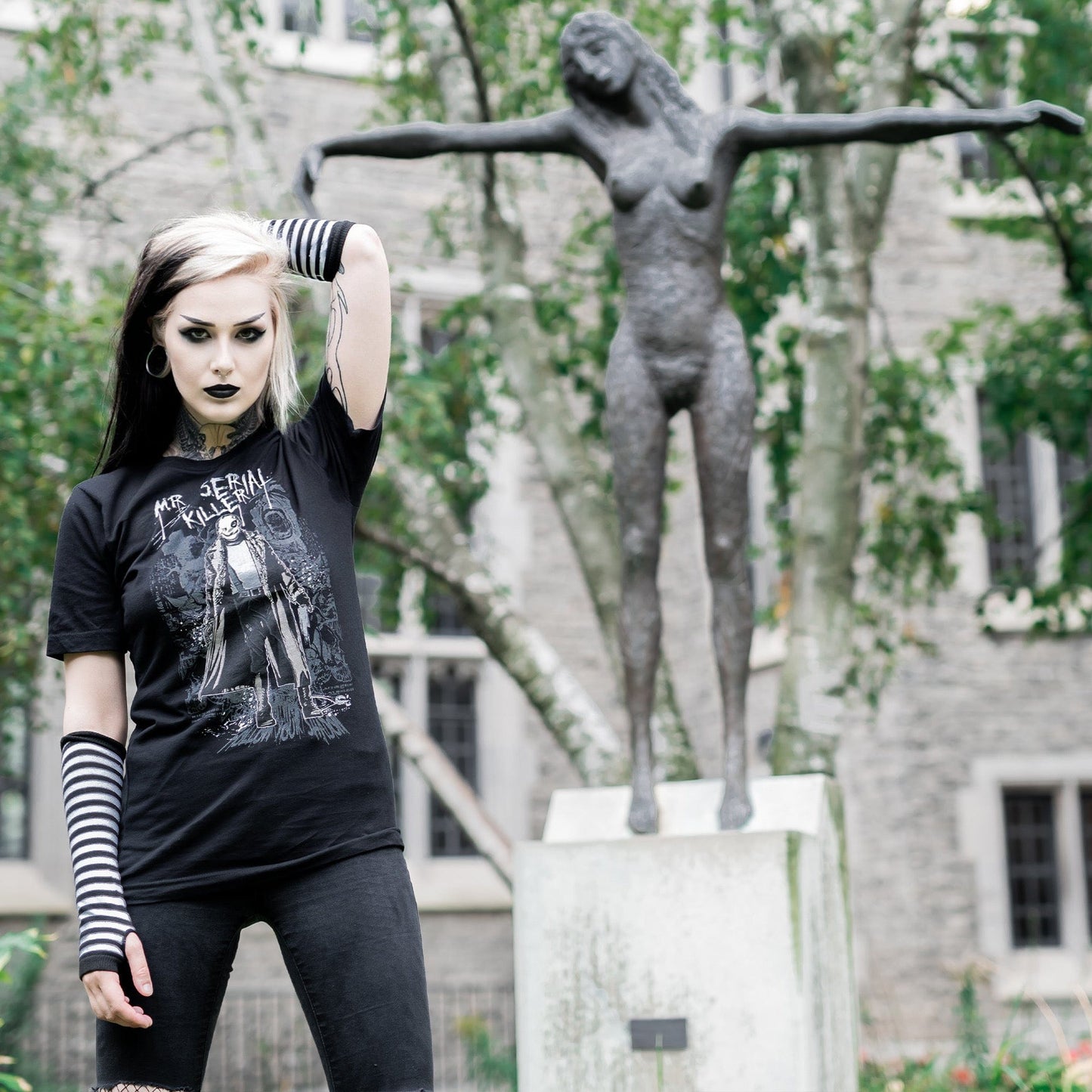 Gothic model wearing the Mr. Serial Killer Follow Your Shadow Graphic T-Shirt in a Victorian setting, capturing dark macabre fashion