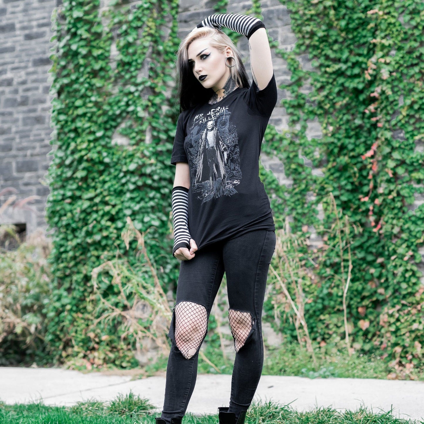 Gothic model wearing the Mr. Serial Killer Follow Your Shadow Graphic T-Shirt in a Victorian setting, capturing dark macabre fashion