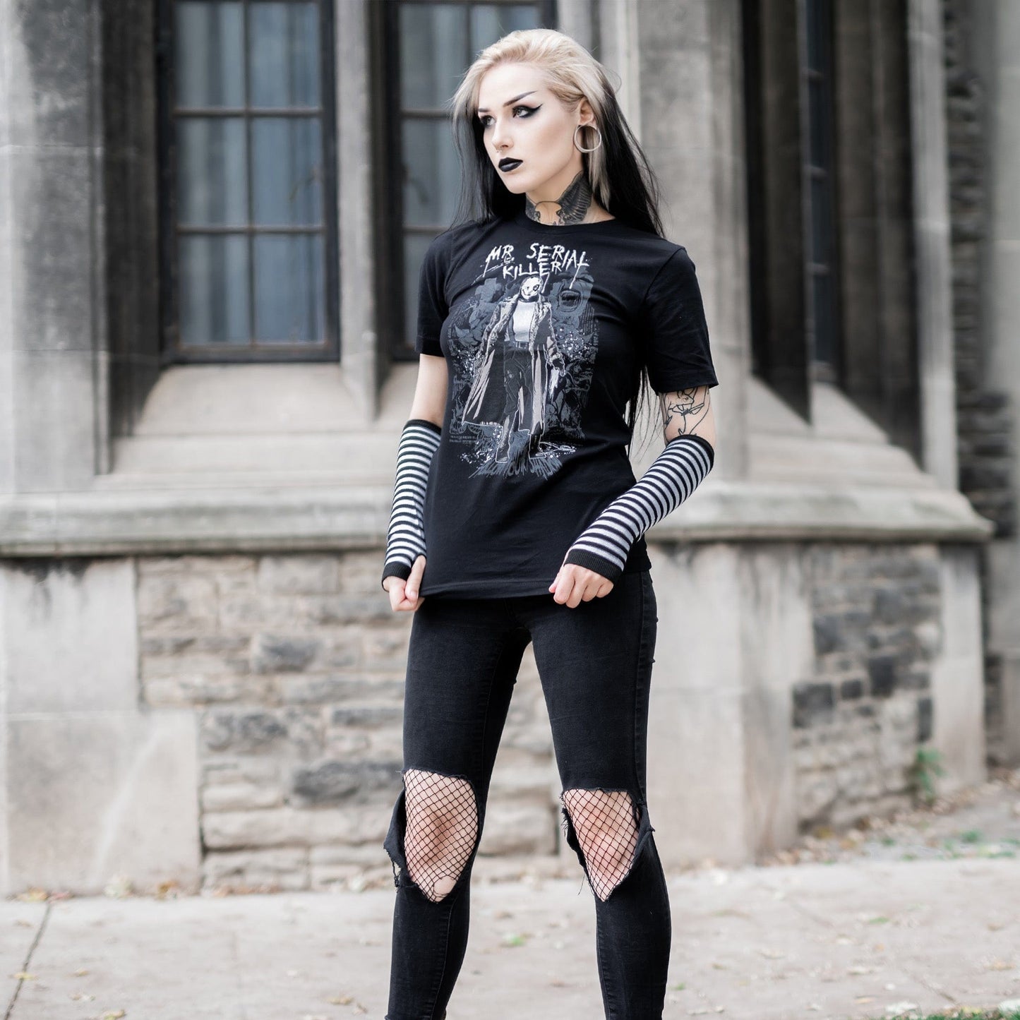 Gothic model wearing the Mr. Serial Killer Follow Your Shadow Graphic T-Shirt in a Victorian setting, capturing dark macabre fashion