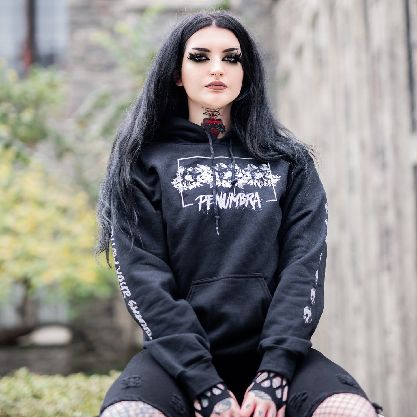 Gothic model wearing the Penumbra Black Hoodie in a Victorian setting, capturing the essence of dark macabre fashion.