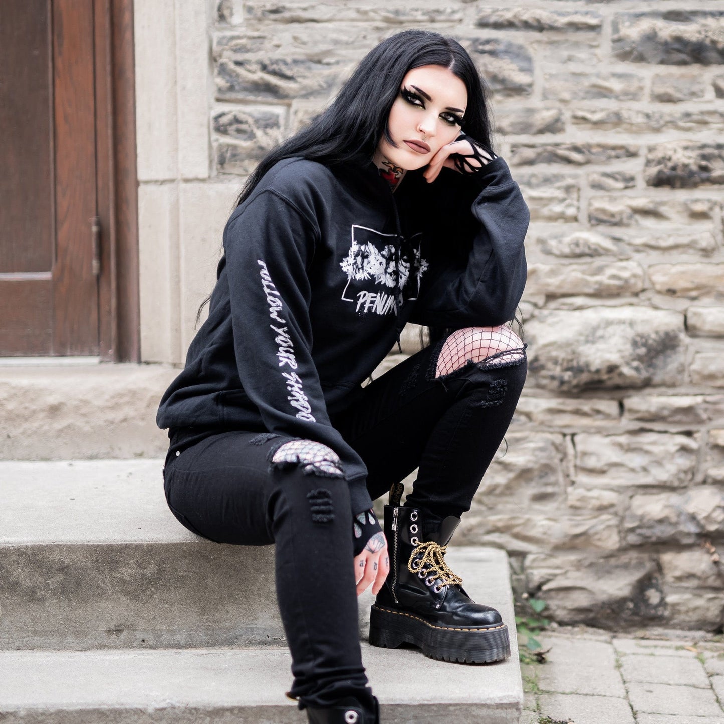 Gothic model wearing the Penumbra Black Hoodie in a Victorian setting, capturing the essence of dark macabre fashion.